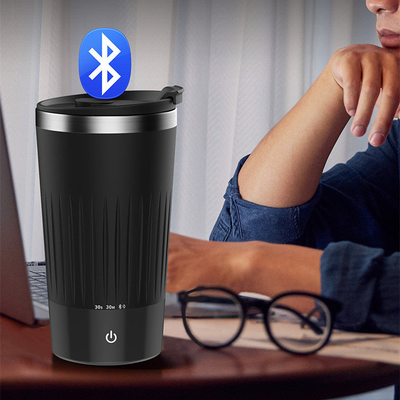 55Degree Thermostatic Automatic Mixing Cup Blender in black with Bluetooth function, placed next to a laptop and glasses for convenient use.