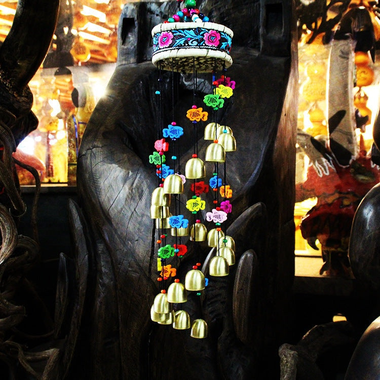 Colorful home wind chime with bells and wooden fish.