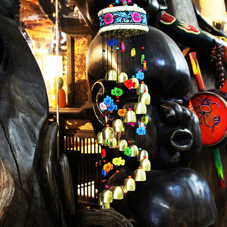Colorful home wind chime with bells and wooden fish.