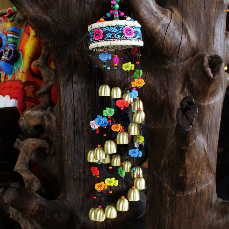 Colorful home wind chime with bells and wooden fish.