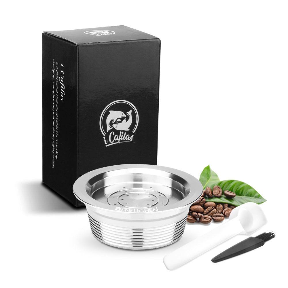 Stainless steel home coffee capsule kit for Lavazza a modo Mio machines, includes two capsules, hammer, grinder, and scoop.