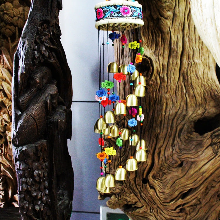 Colorful home wind chime with bells and wooden fish.Home 
